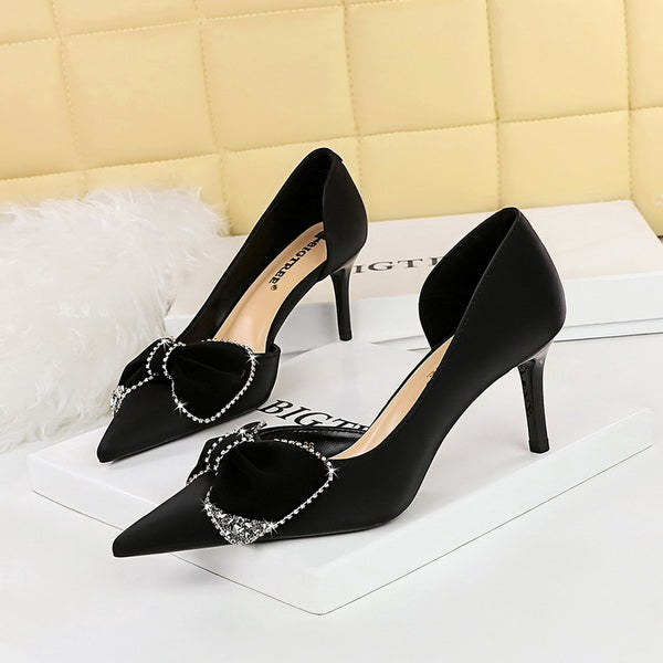 Pointed toe, cut-out panels, rhinestone bow heels